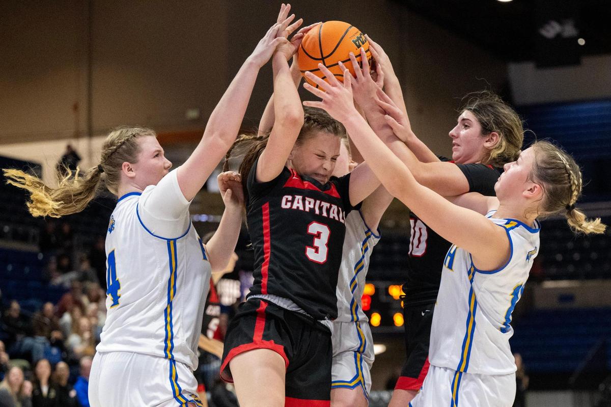 Sacramento Adventist Academy’s Gwen Rosich battles Faith Christian players for a rebound during the CIF Sac-Joaquin Section Division VI girls basketball championship game at UC Davis on Friday in Davis.
