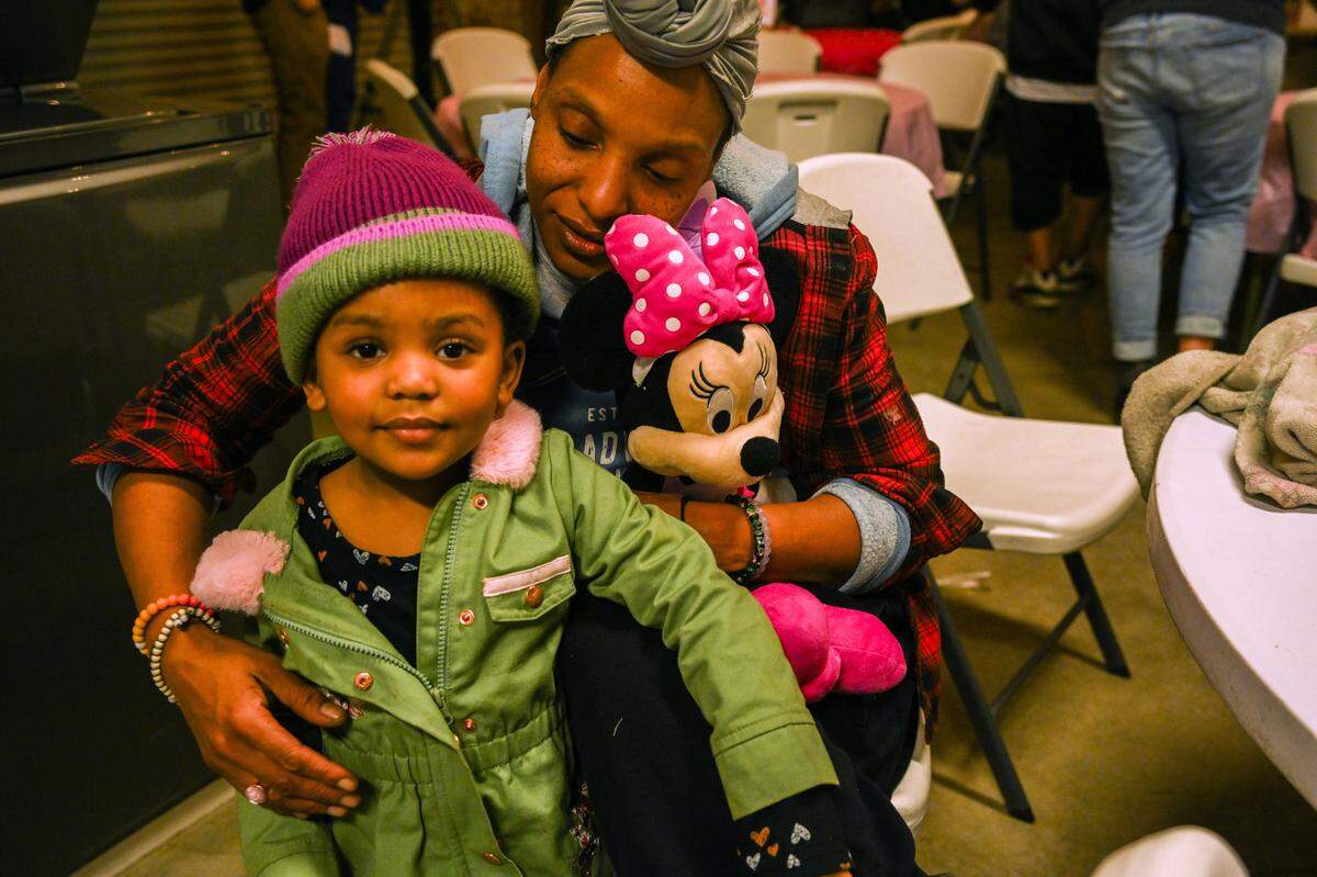 Tanika Williams holds her daughter Makhila, 2, who has sickle cell anemia, at a press conference on Feb. 14, where she spoke about her family’s plight after they were locked out of their room at a motel that serves as a city homeless shelter. 