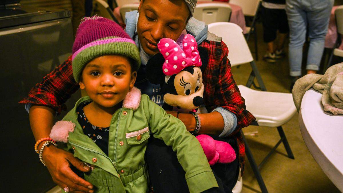 Tanika Williams holds her daughter Makhila, 2, who has sickle cell anemia, at a press conference on Wednesday where she spoke about her family's plight after they were locked out of their room at a motel that serves as a city homeless shelter. 