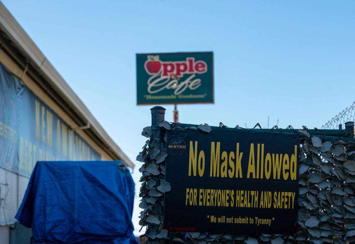 “No Mask Allowed FOR EVERYONE’S HEALTH AND SAFETY,” reads a sign at Apple Bistro in Placerville on Feb. 1, 2022.