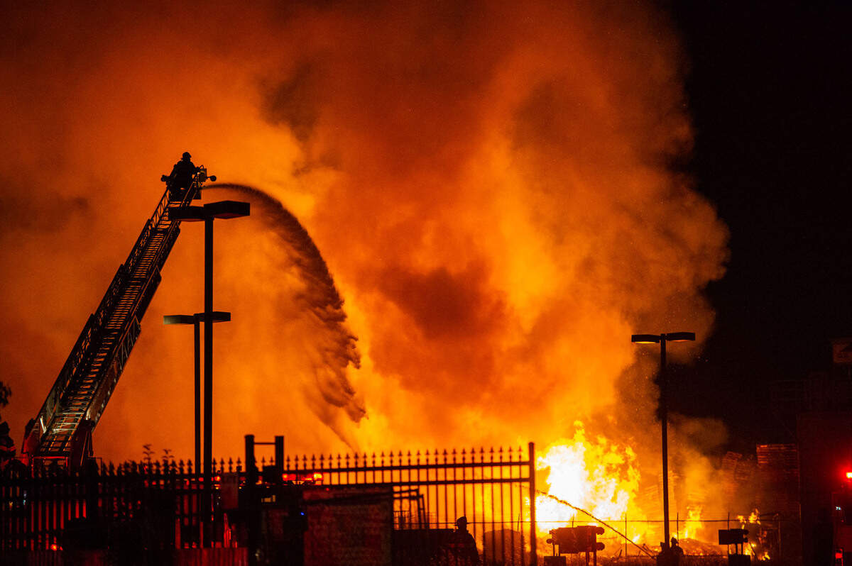 Firefighters battle a large pallet fire in an industrial section of Sacramento on Tuesday night, May 31, 2022.