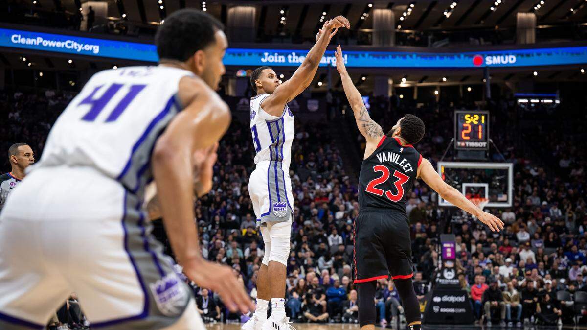 Sacramento Kings forward Keegan Murray (13) shoots a three point basket over Toronto Raptors guard Fred VanVleet (23) during the second quarter of the NBA basketball game Wednesday, Jan. 25, 2023, at Golden 1 Center in Sacramento.
