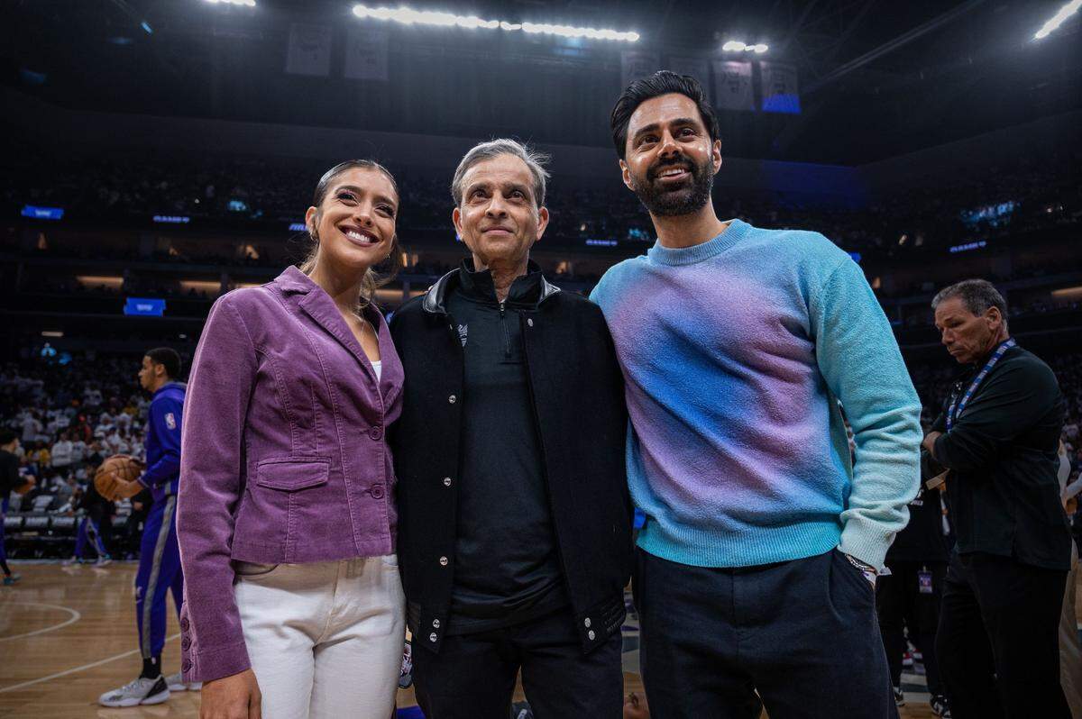 Comedian Hasan Minhaj, right, poses for a photo with Sacramento Kings owner Vivek Ranadivé, center, and daughter Ranadivé Anjali before Game 7 of the conclusion of the first-round NBA playoff series at Golden 1 Center on Sunday.