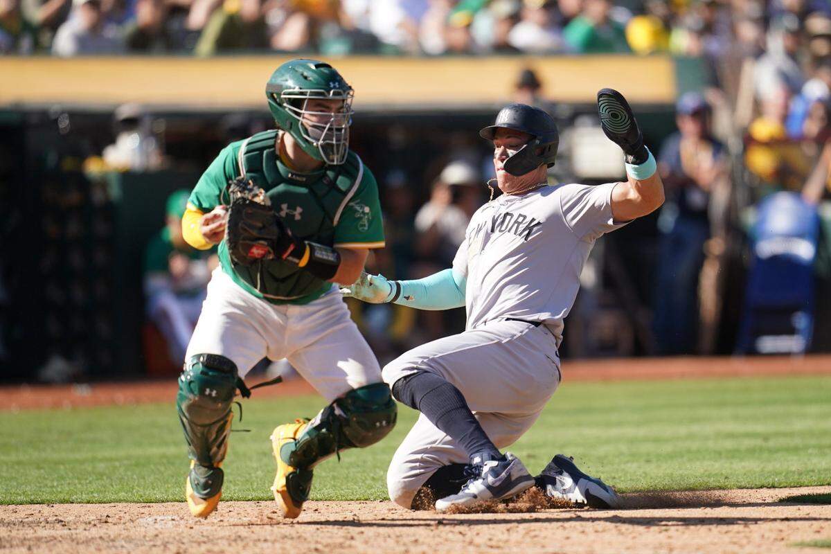 Sep 22, 2024; Oakland, California, USA; New York Yankees center fielder Aaron Judge (99) is forced out at home by Oakland Athletics catcher Shea Langeliers (23) in the ninth inning at the Oakland-Alameda County Coliseum. Mandatory Credit: Cary Edmondson-Imagn Images