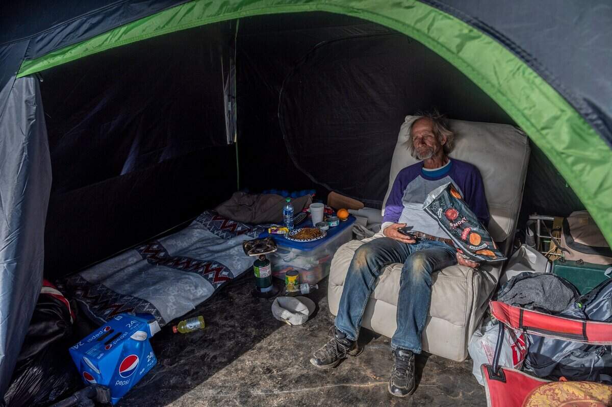 Roy Warren, 63, sits inside his tent in a homeless camp in Auburn on Jan. 21. “I’m just trying to survive.” he said. “I want to see my grandkids but I’m not bringing them here.”