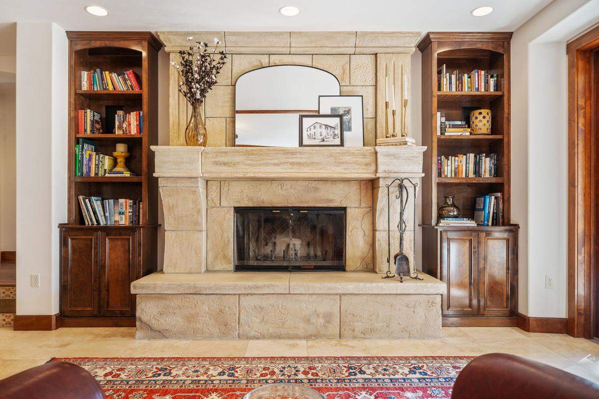 The fireplace in an elegant great room is warm for winters, inviting, and perfect for relaxing evenings.