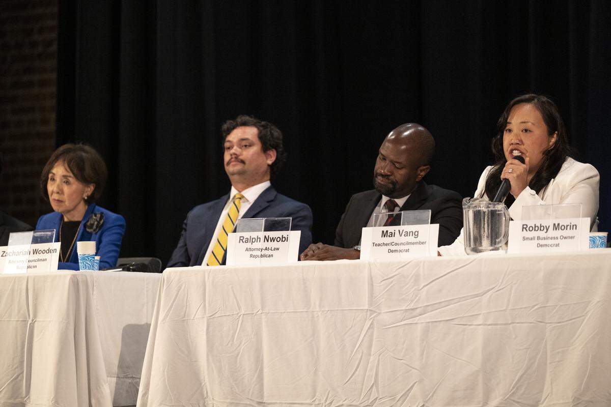 Mai Vang, right, speaks during a congressional candidate forum for CA District 7 at Coloma Center in Sacramento on Thursday, April 2, 2026, as candidates, from left, Doris Matsui, Zachariah Wooden and Ralph Nwobi listen.