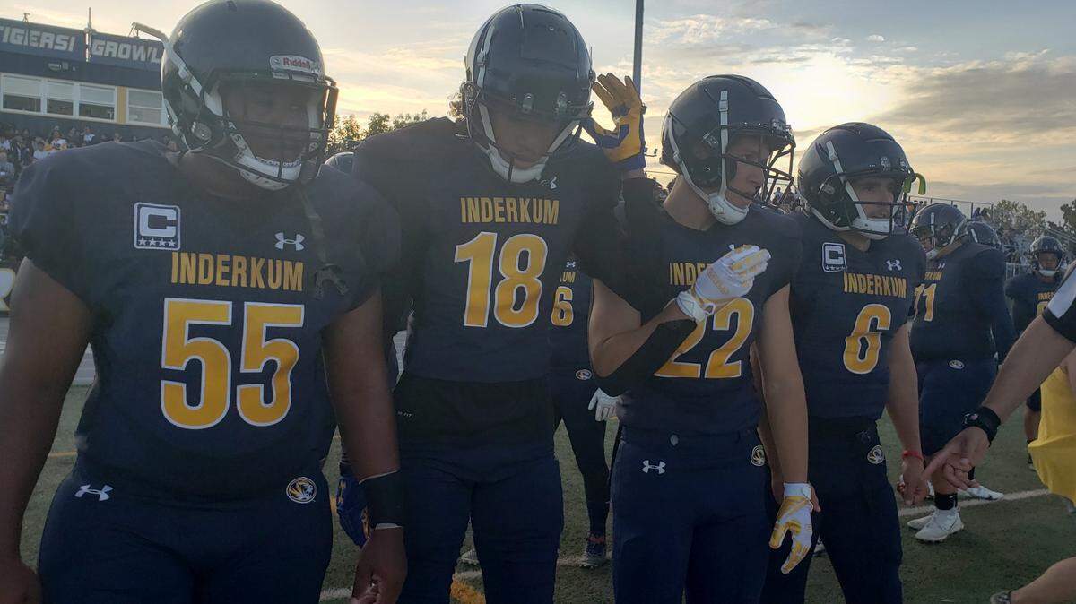 Inderkum High School captains Omarion Overby, Lono Chouteau, Isaac Estacio and Ricky Cole walk on to the field for the coin toss before Friday’s season-opener against Monterey Trail.