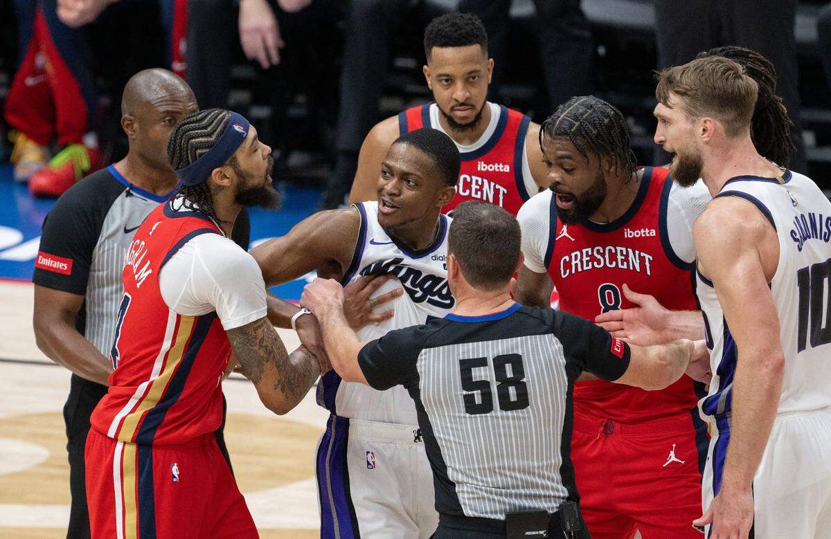 Sacramento Kings guard De’Aaron Fox (5) gets in a heated conversation with New Orleans Pelicans forward Brandon Ingram (14) and forward Naji Marshall (8) during an NBA play-in game at Smoothie King Center in New Orleans on Friday, April 19, 2024.