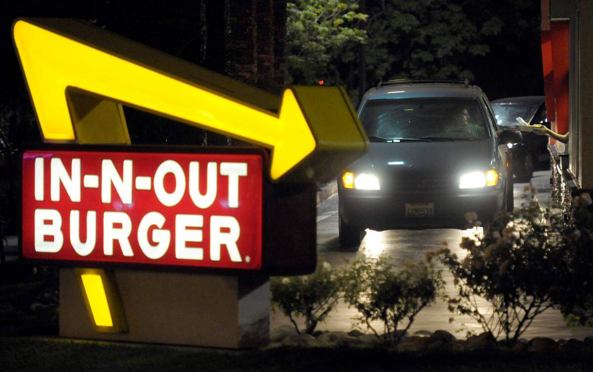 In this June 8, 2010, file photo, a customer receives an order from the drive-through at an In-N-Out Burger.