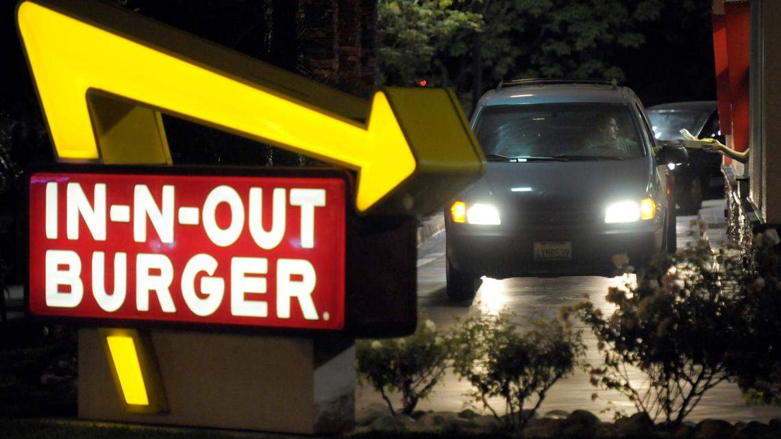 In this June 8, 2010, file photo, a customer receives an order from the drive-through at an In-N-Out Burger.