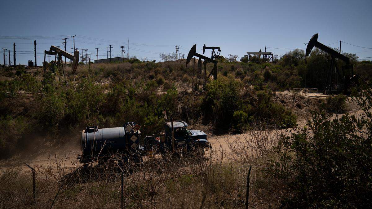 A truck drives past pump jacks operating at the Inglewood Oil Field Thursday, June 10, 2021, in Los Angeles.