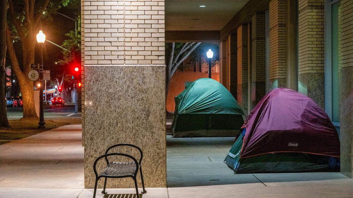 Tents stand outside Sacramento City Hall on July 15, 2025. Several homeless people said they like sleeping at City Hall because they feel safe, there is an overhang to keep them dry from the rain, security is present, and the area is well lit. 