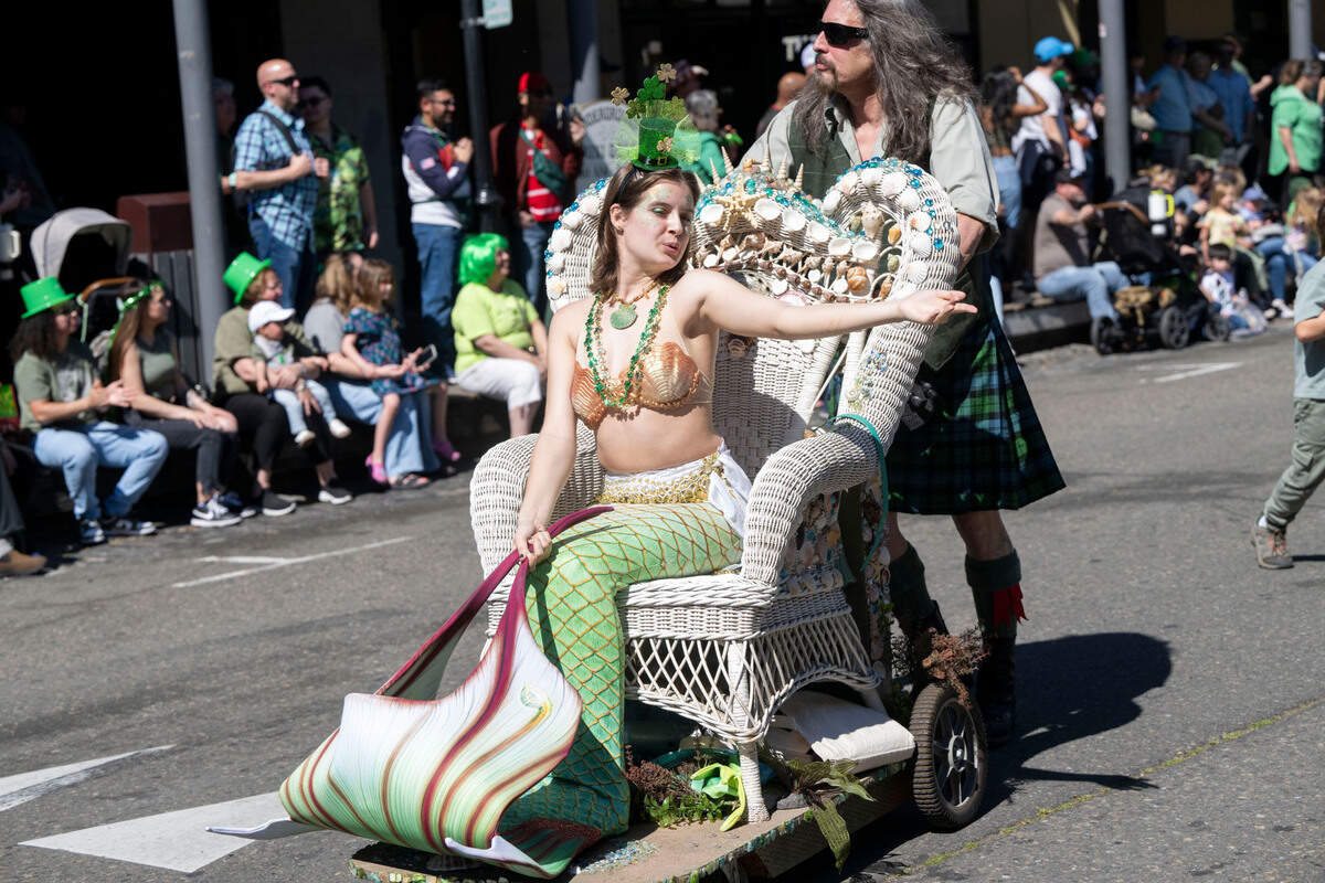 Alyssa Punch with the California Mermaid Convention blows a kiss while taking part in the annual St. Patrick’s Day parade in Old Sacramento on Saturday.