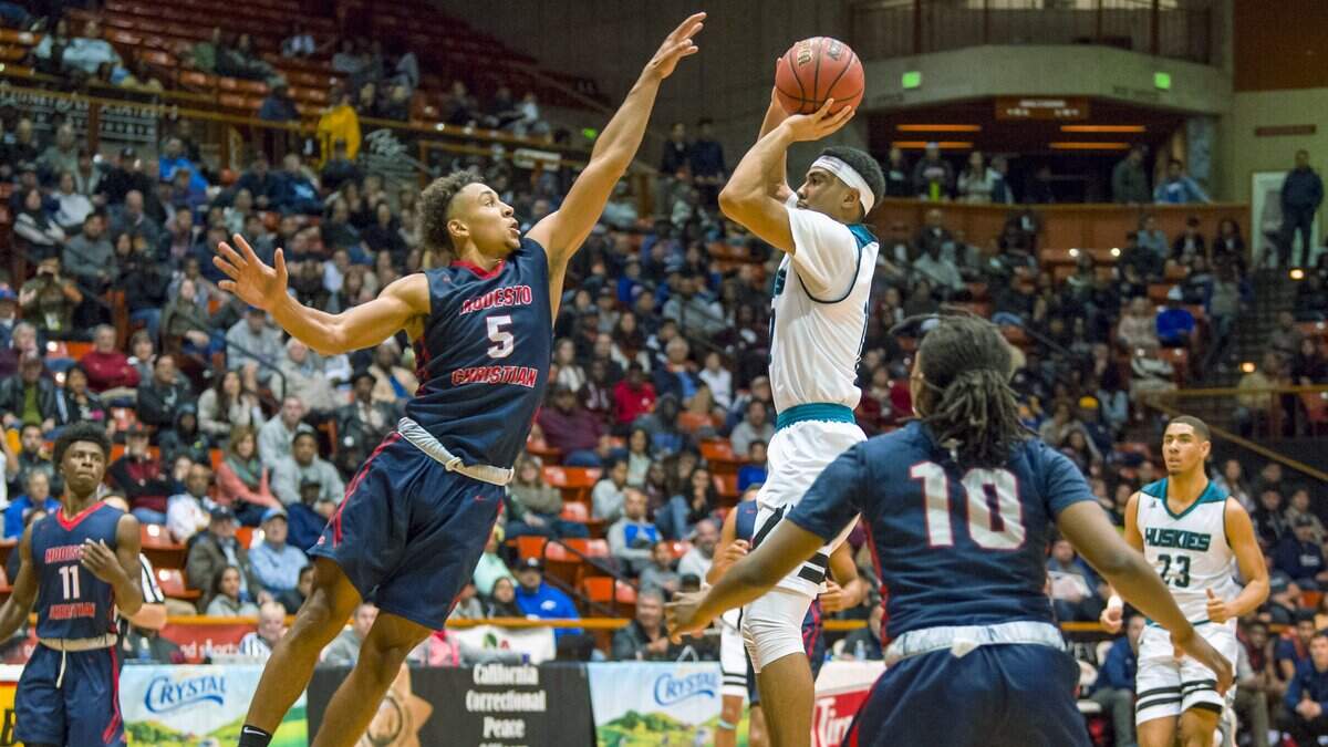 Sheldon's Kaito Williams shoots while being defended by Modesto Christian's Junior Ballard (5) in the CIF Division I Section championship game in the Spanos Center at Pacific on March 3.