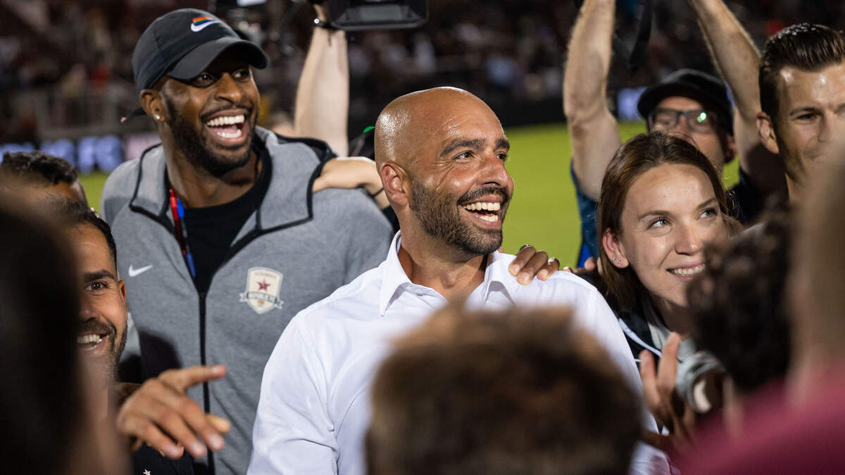 Sacramento Republic FC head coach Mark Briggs smiles and talks with his team after beating Sporting Kansas City after regulation time, two overtime periods and penalty kicks at the U.S. Open Cup semifinal soccer game at Heart Health Park on Wednesday, July 27, 2022, in Sacramento.