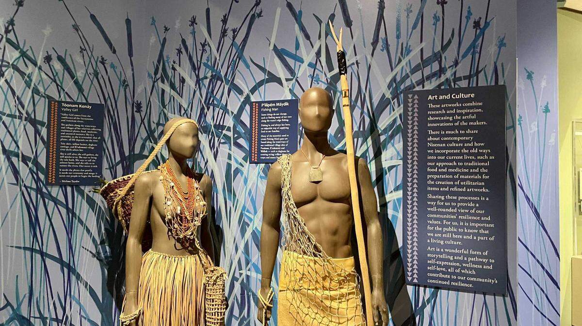 Two mannequins, named “Valley Girl” and “Fishing Man,” are dressed in traditional tribal attire in a new museum display at the Sacramento History Museum. The exhibit, which opened on July 22, 2023, is called Mómtim Péwinan, or River People, and showcases the culture of the native people of the Sacramento River area.