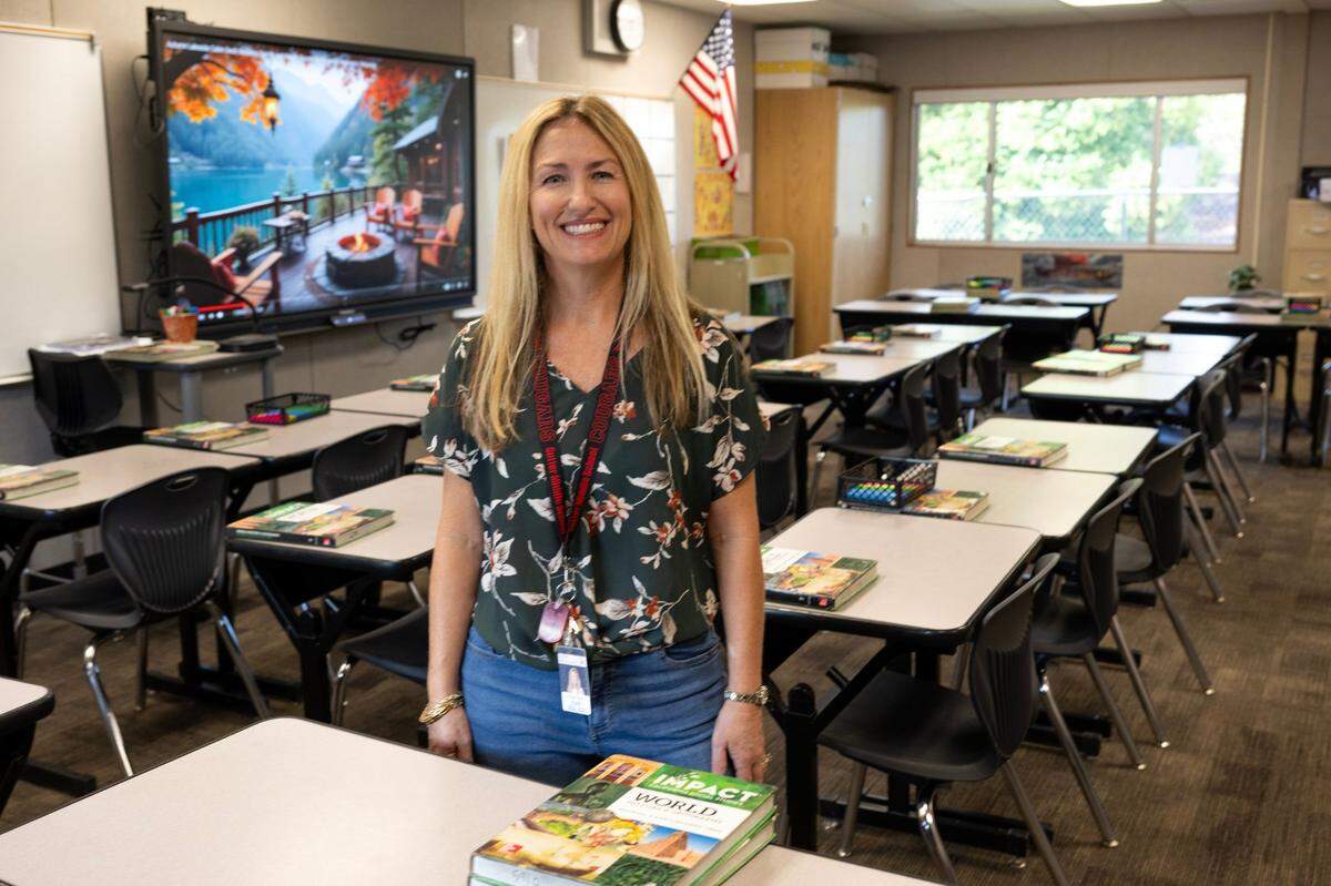 Lindsay Castro stands in her 7th grade social studies at Sutter Middle School classroom in Folsom on Thursday. She said that banning of cell phone use has been helpful for student interaction in the classroom.