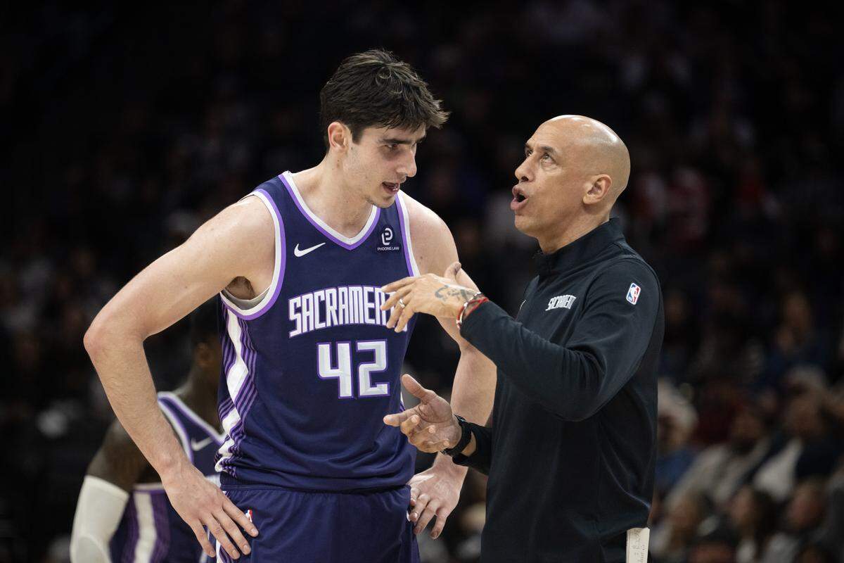Sacramento Kings coach Doug Christie talks with center Maxime Raynaud (42) during a timeout in the second half against the Portland Trail Blazers on Saturday, Dec. 20 at Golden 1 Center in Sacramento.