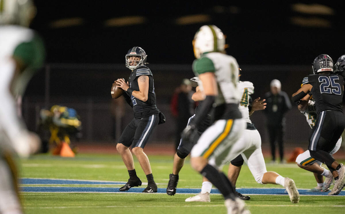 Vista del Lago Eagles quarterback Johnny Koett (12) looks downfield before finding receiver Matthew Werpy for the opening touchdown in a CIF Sac-Joaquin Section playoff quarterfinal Friday in Folsom.
