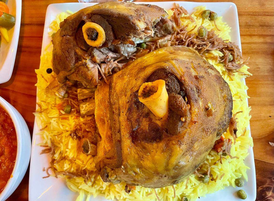 Sumer Nights’ quzi features two hulking lamb legs over Iraqi pilaf.