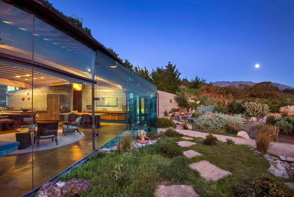 A 2004 Big Sur home designed by architect Mickey Muennig is going on sale for the first time ever at $35 million. The modern, eco-friendly home features huge walls of glass and is built into a ridge with a sod roof in a way that makes it “disappear into the landscape,” according to Coldwell Banker Realty.