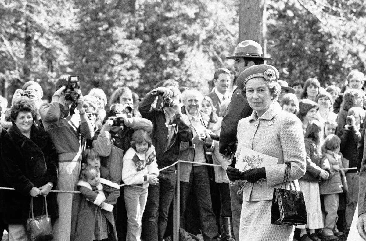 Pleased visitors to Yosemite National Park get a glimpse of Queen Elizabeth II on Sunday, March 7, 1983 as she left the Community Church chapel following services.