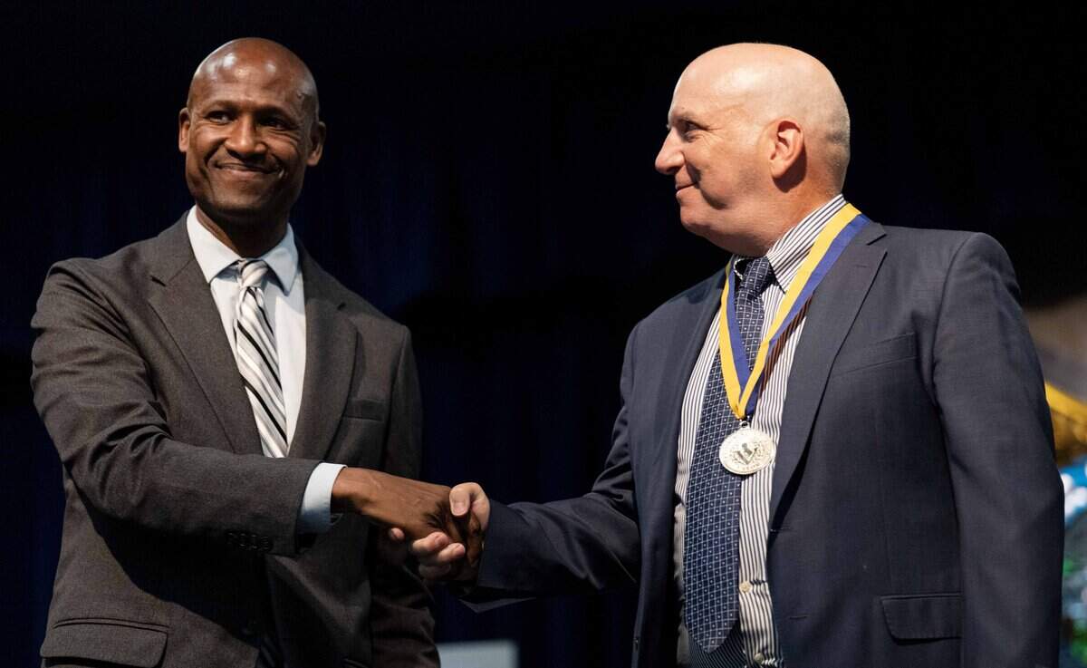 John Shipley, right, an attorney with the California State Teachers’ Retirement System, receives a silver Governor’s State Employee Medal of Valor at the California Highway Patrol Academy in West Sacramento on Friday. Shipley received the medal for his bravery in protecting a Little League team in Davis during an active shooter event until law enforcement could secure the area.