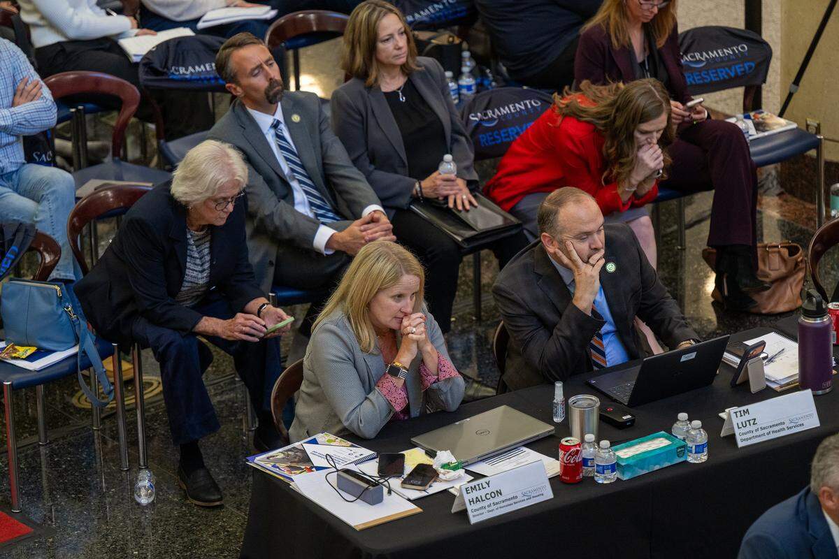 Emily Halcon, left, Sacramento County Director of Homeless Services and Housing, listens alongside Tim Lutz, right, of the Sacramento County Department of Health Services, during a joint city-county review of homelessness at the Tsakopoulos Library Galleria in Sacramento in October.