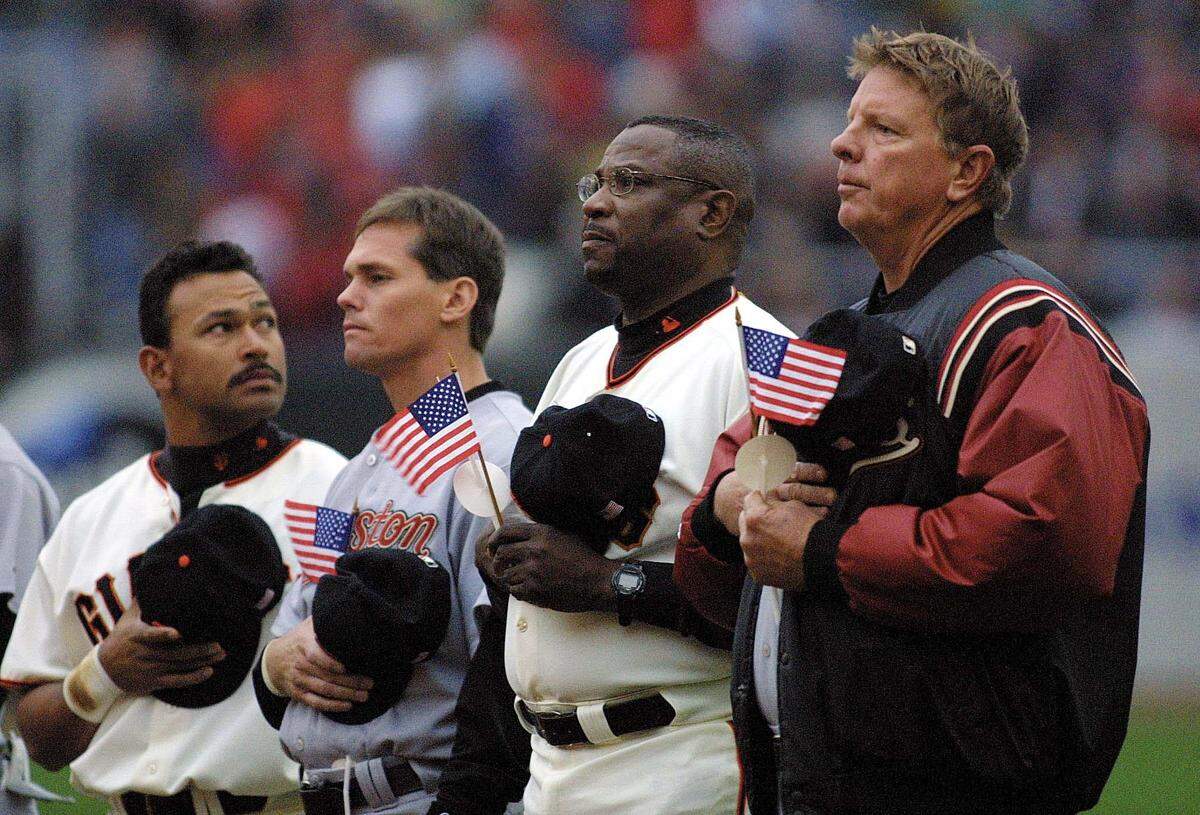 The San Francisco Giants’ Marvin Benard, left, looks into the stands before a game in 2001 with the Houston Astros' Craig Biggio, Giants manager Dusty Baker and Astros manager Larry Dierker, right.