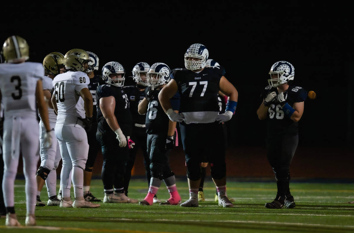 Casa Roble tackle Sunia Vuki (77), a 6-foot-5, 353-pound sophomore, towers over his teamamtes during their game against the Pioneer Patriots on Friday.