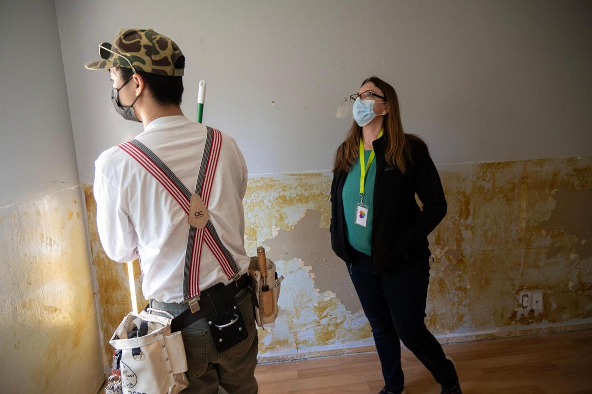 Alyssum Maguire talks with maintenance worker Jason Chu about the renovations in one of the three bedrooms at one of their two homes in Davis in December. The facility would like to add more beds, but it faces several obstacles.