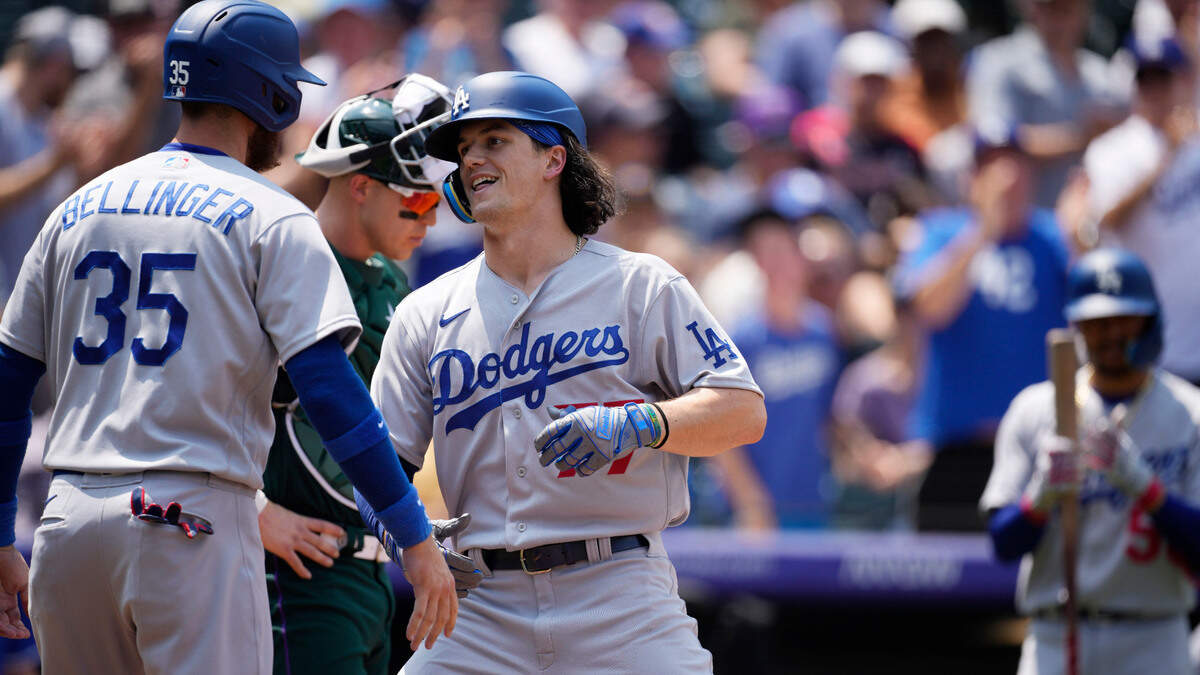 Los Angeles’ James Outman celebrates with Cody Bellinger after hitting a two-run home run off Colorado Rockies starting pitcher German Marquez on Sunday, July 31, 2022, in Denver.