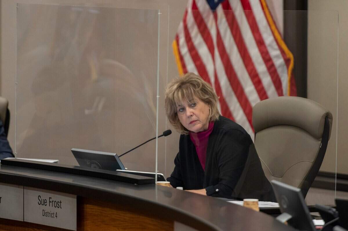 Sacramento County Supervisor Sue Frost is surrounded by a transparent screen as she listens to public comment during the board’s meeting at the County Administration Building in downtown Sacramento on Tuesday, Aug. 24, 2021. Frost was the only supervisor who didn’t wear a mask at the meeting.