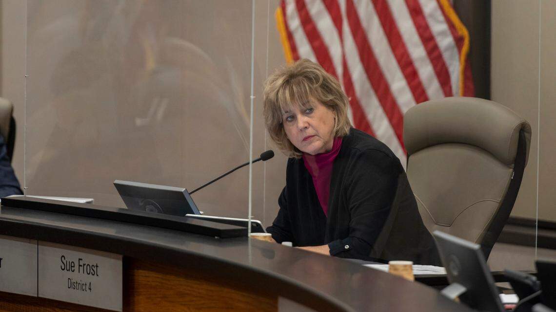 Sacramento County Supervisor Sue Frost is surrounded by a transparent screen as she listens to public comment during the board’s meeting at the County Administration Building in downtown Sacramento on in 2021. Frost was the only supervisor who didn’t wear a mask at the meeting.