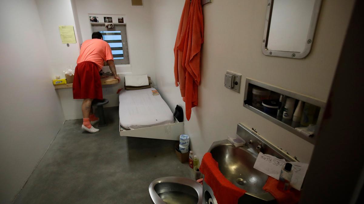 In this 2019 file photo, an inmate looks out a window in his solitary confinement cell at the Main Jail in San Jose. A bill limiting the placement of inmates in solitary, vetoed last year by Gov. Gavin Newsom, has been reintroduced. (AP Photo/Ben Margot, File)