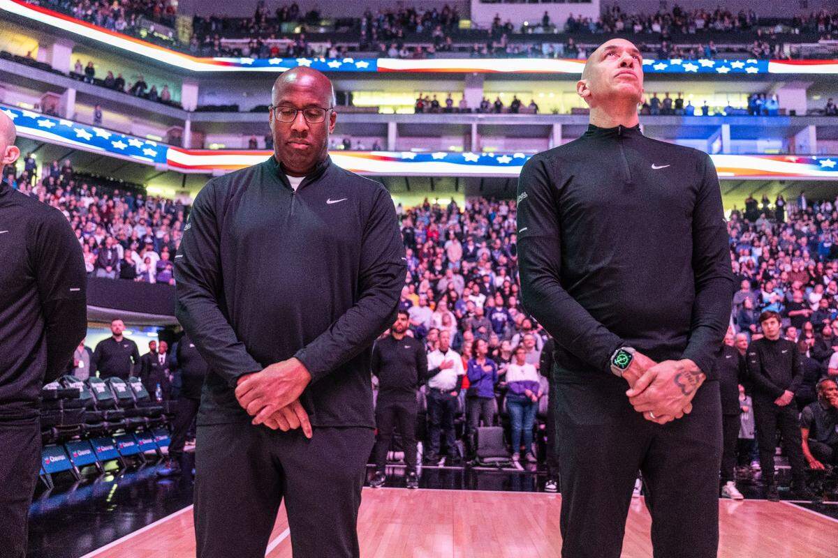 Sacramento Kings head coach Mike Brown and assistant Doug Christie stand for the National Anthem during an NBA game against the Detroit Pistons on Feb. 7, 2024 at Golden 1 Center. 
