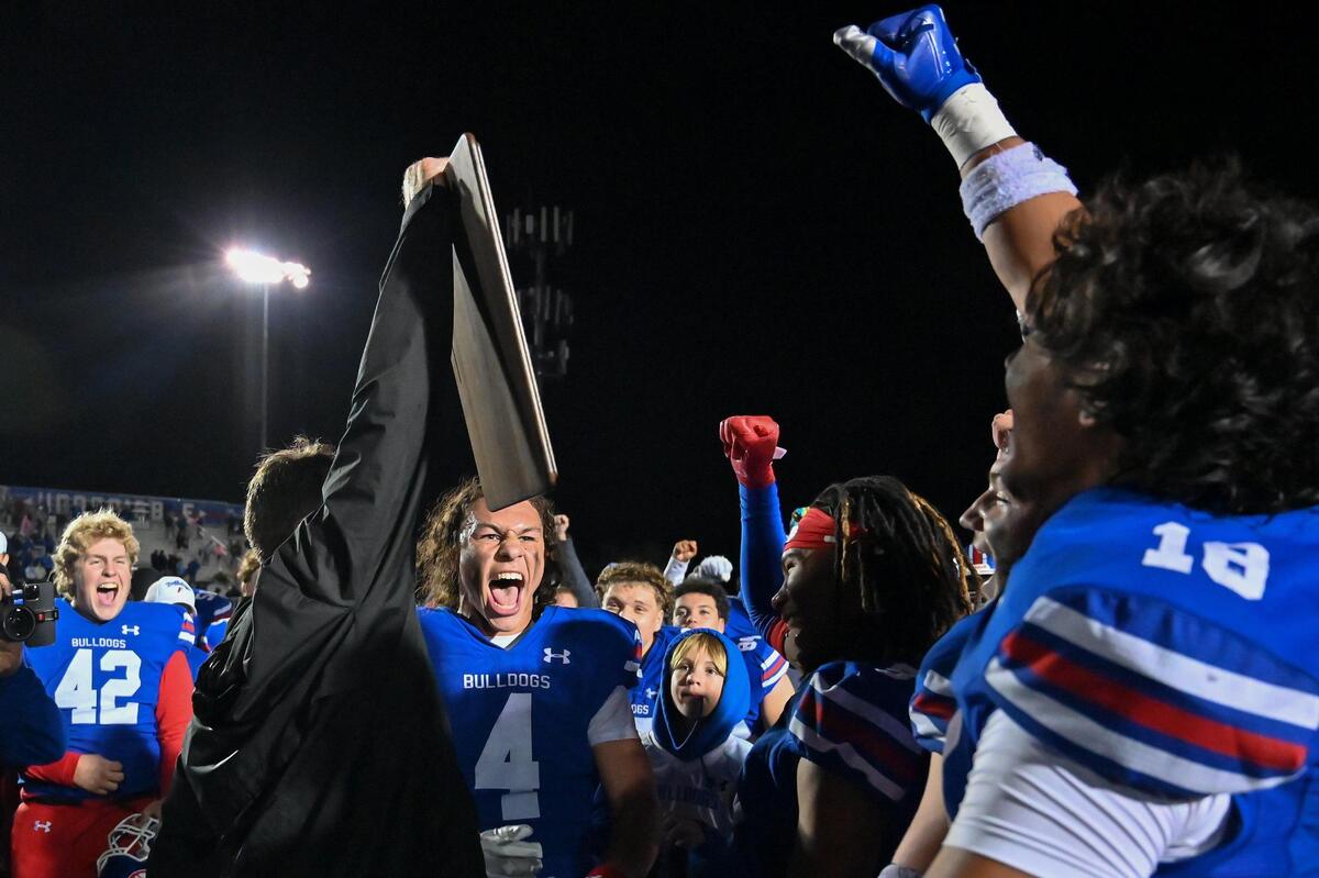 The Folsom Bulldogs celebrate after coach Paul Doherty receives the championship plaque after winning the CIF Northern California Division 1-A championship against the Pittsburg Pirates on Saturday, Dec. 2, 2023, at Folsom High School.