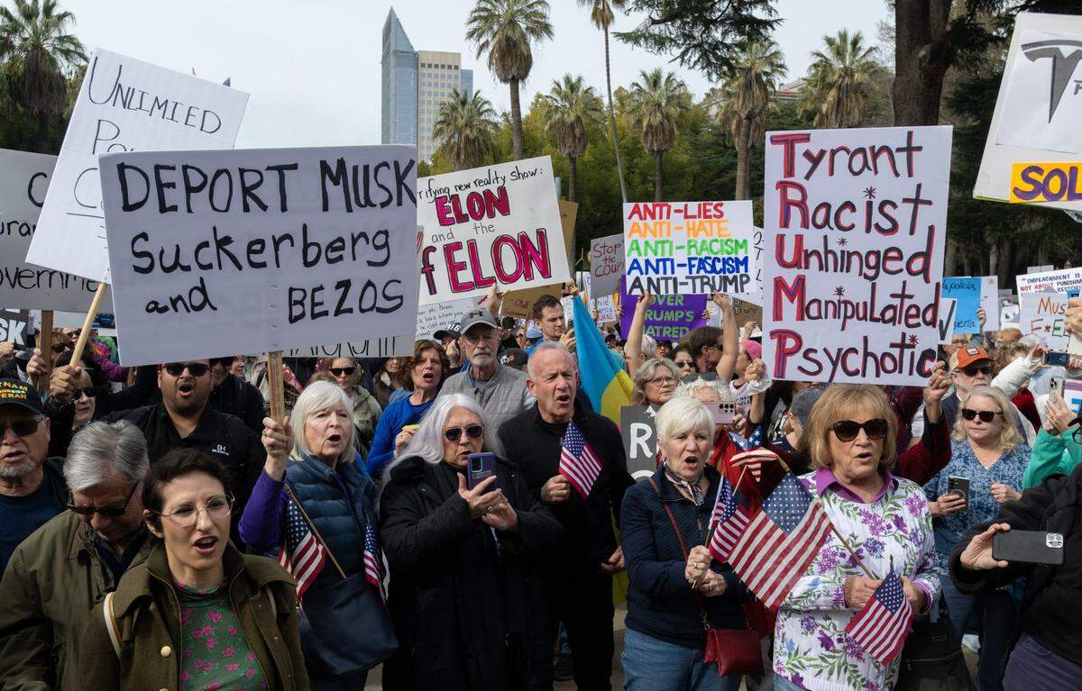 Former Sacramento Mayor Darrell Steinberg, center, and others participate in a President’s Day protest against President Donald Trump organized by the members of 50501 at the Capitol last month.