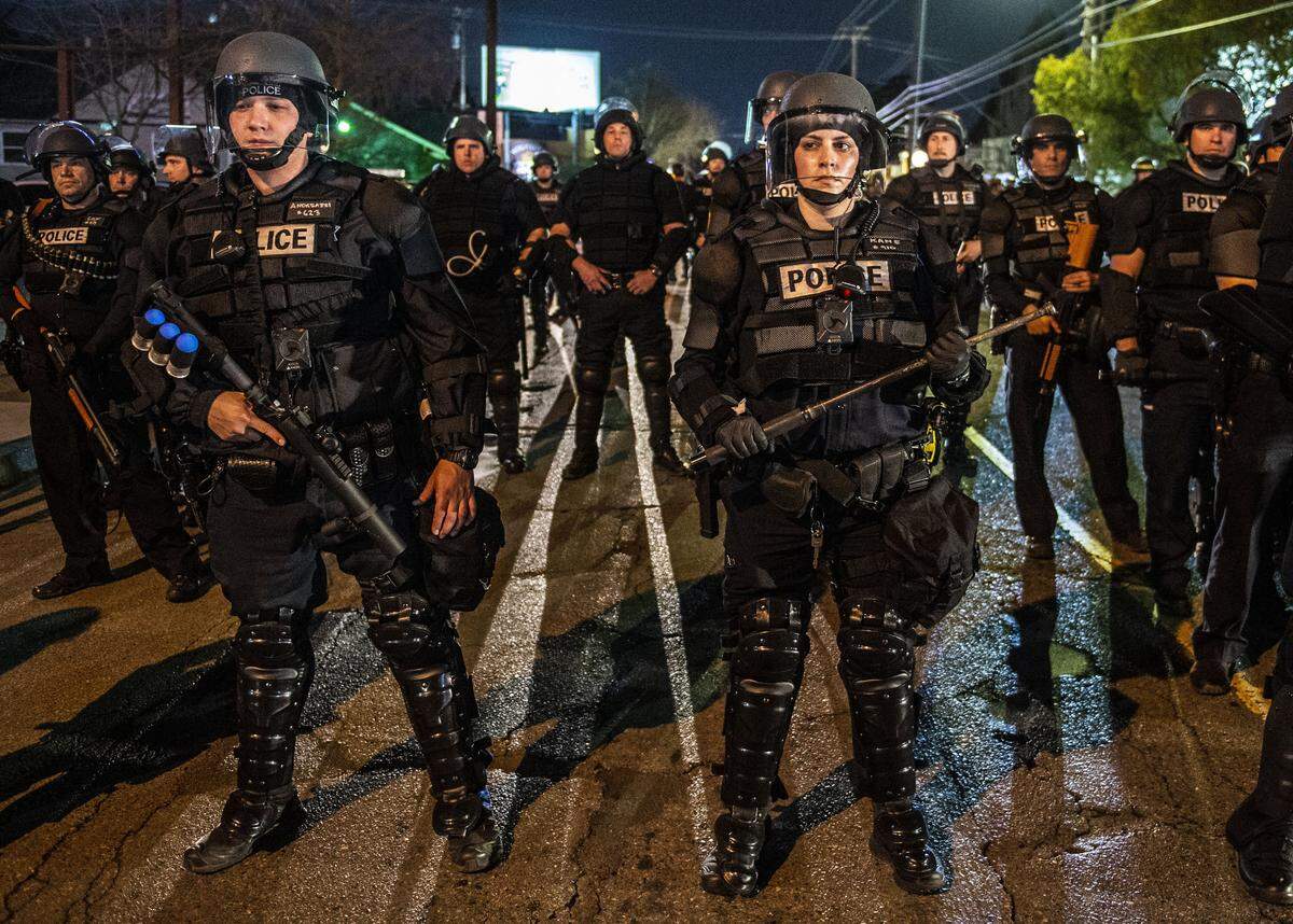 Sacramento police officers block Folsom Boulevard during a Stephon Clark march in the Fabulous 40s on Monday. The march ended with more than 80 people arrested.