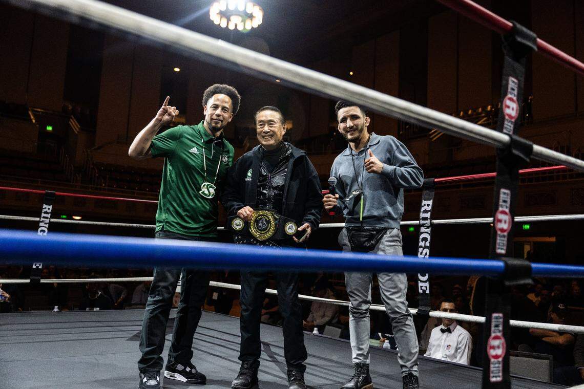 Sacramento State president Luke Wood honors Roger Fong, who boxed for the school’s boxing team years ago, during the Causeway Boxing Classic at Sacramento’s Memorial Auditorium on Friday. Hector Fajardo, director of operations for Combat U, stands at right.