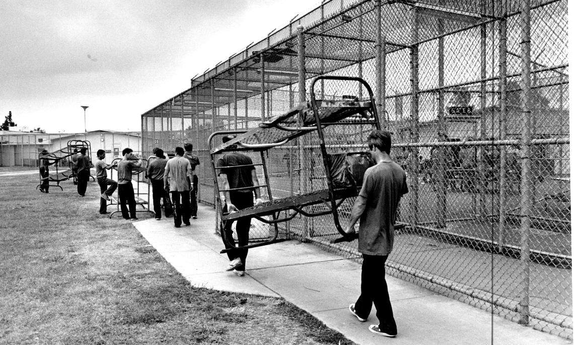 Inmates at the Rio Cosumnes Correctional Center in Elk Grove move bunks to the old recreation hall, which will soon hold up to 80 prisoners, in 1988. A total of up to 200 prisoners from the main jail will be housed at the Elk Grover branch.