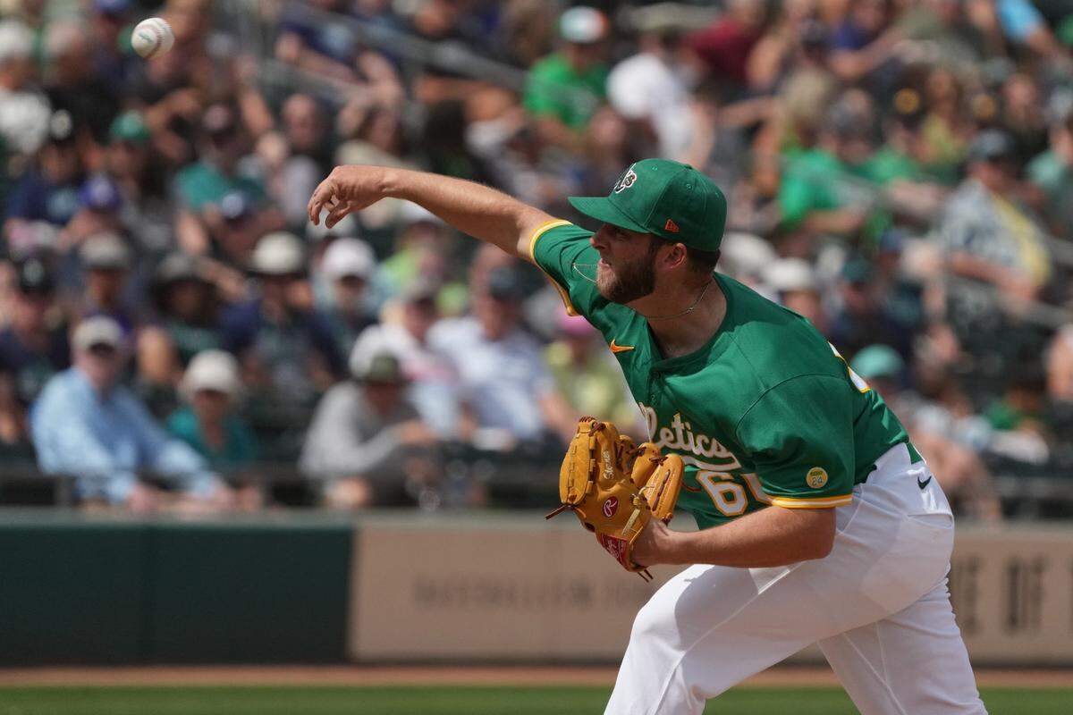 Mar 17, 2025; Mesa, Arizona, USA; Oakland Athletics pitcher Justin Sterner (60) throws against the Seattle Mariners in the first inning at Hohokam Stadium. Mandatory Credit: Rick Scuteri-Imagn Images