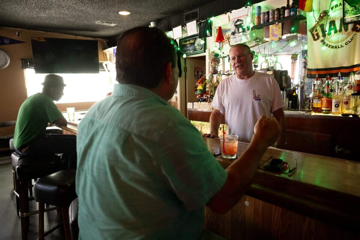 Owner Daniel Delagnes talks with longtime customer Regino Zertuche at the Round Corner Tavern in Sacramento on June 6, 2025. Deranges has seen an increase in business after the Channel 24 concert venue opened next door, He has worked at the bar since 1987 and owned it since 2001.