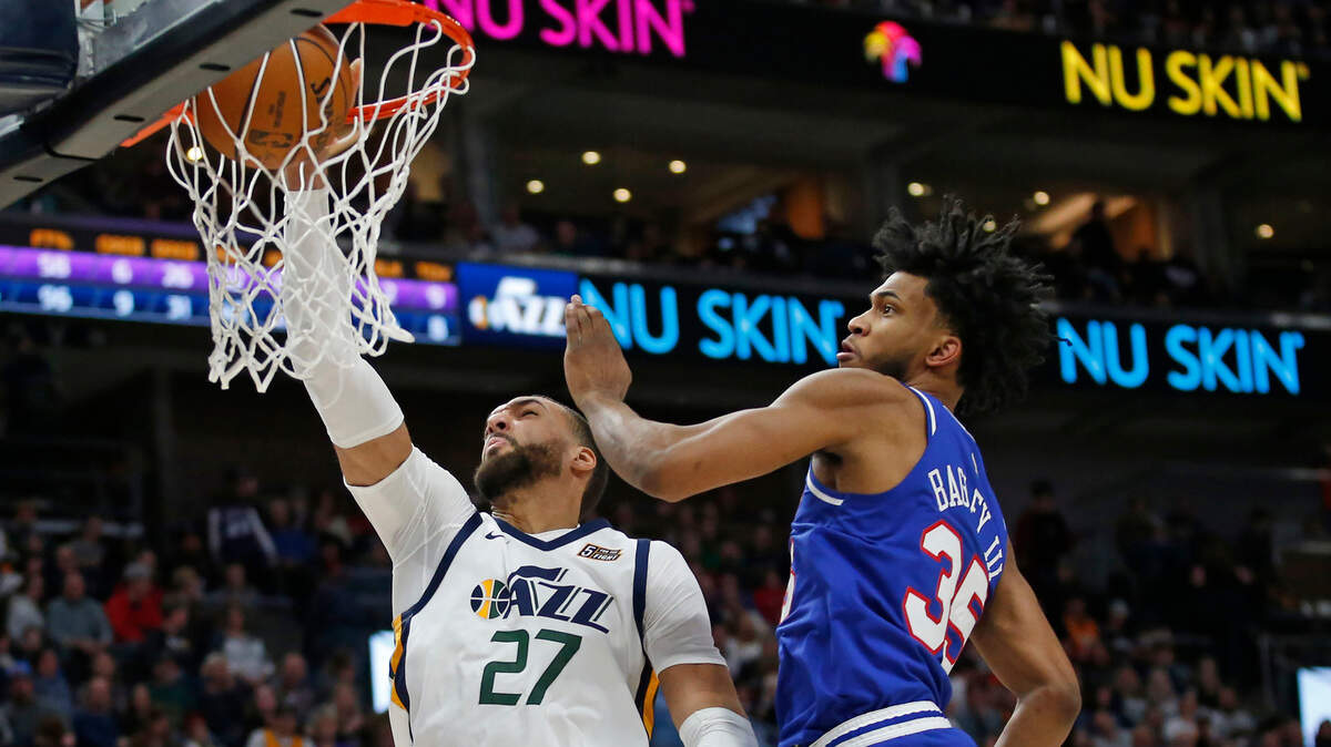 Utah Jazz center Rudy Gobert dunks next to Sacramento’s Marvin Bagley III on Saturday.