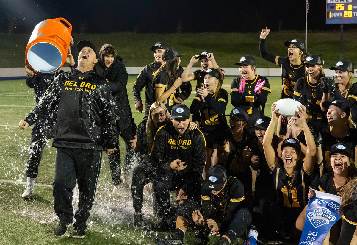 Del Oro coach Steven Birch is doused with water after his team won the Sac-Joaquin Section girls flag football Division I championship game at Cosumnes River College in Sacramento on Saturday.