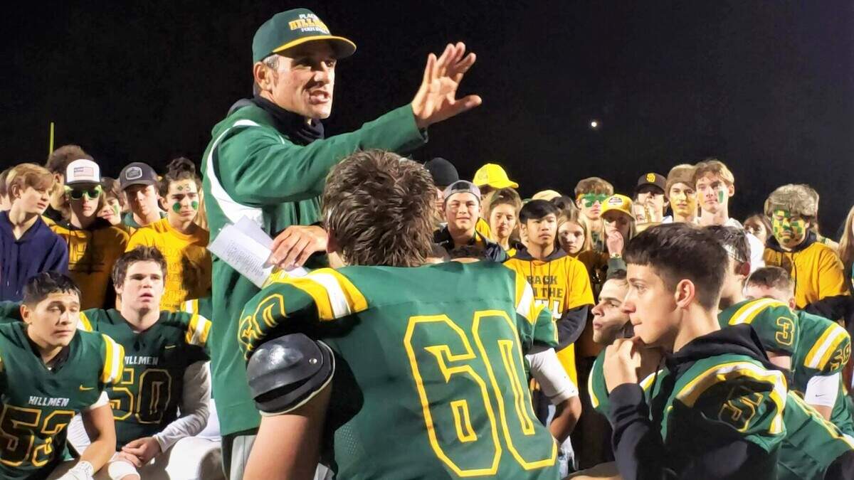 Placer High football coach Joey Montoya talks to the Hillmen after a playoff win Friday night.