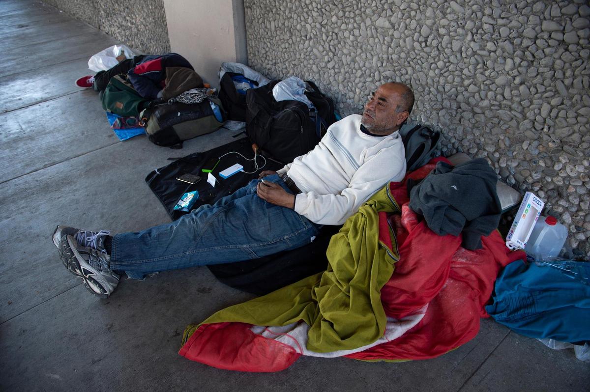 Richard Tony Sanchez, 55, sits under a freeway overpass on T Street, Thursday, March 21, 2019, in Sacramento with his brother who are both experiencing homelessness.