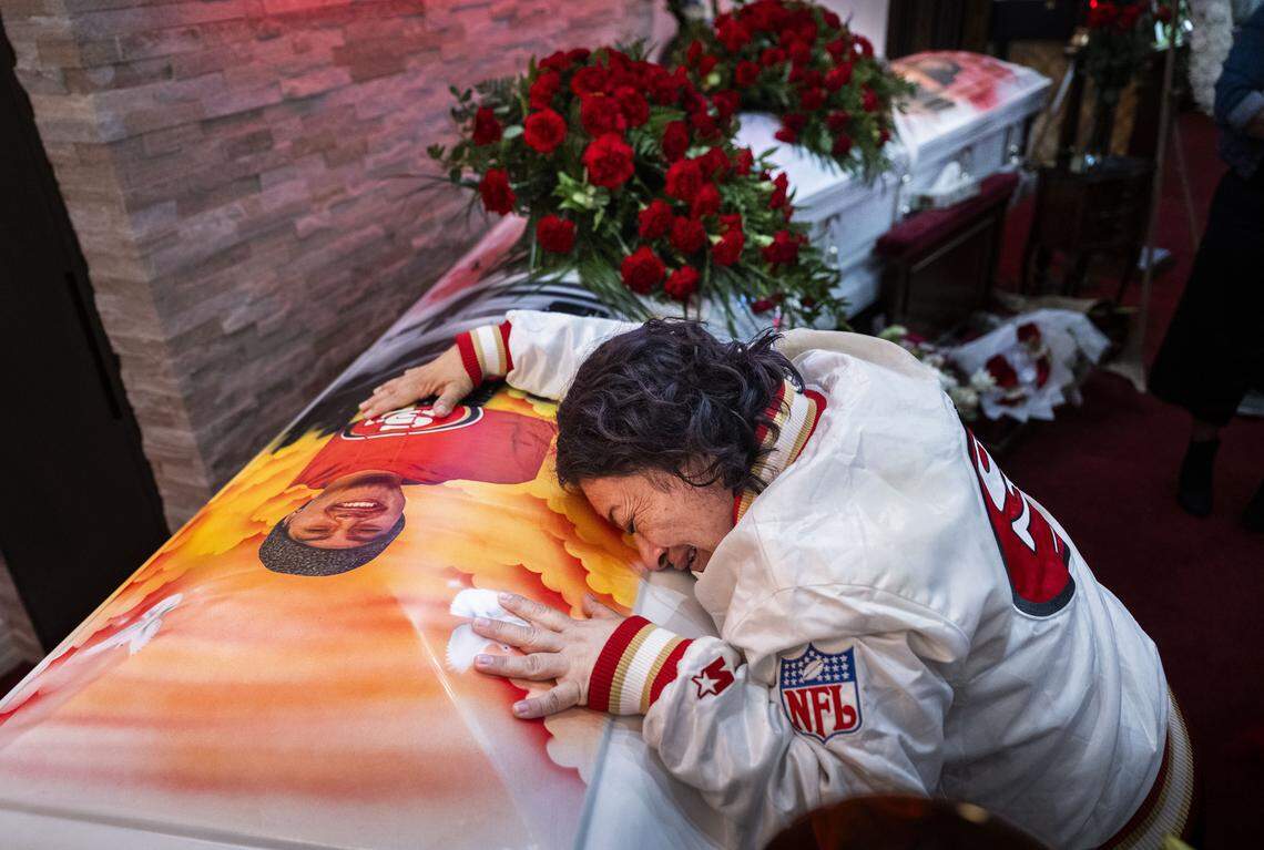 Marisol Hernandez, the mother of Jesus and Jhony Ramos, the brothers killed at a fireworks facility in Esparto along with five others, cries over the coffin of Jhony during a wake on Sunday, July 27, 2025, in Daly City.