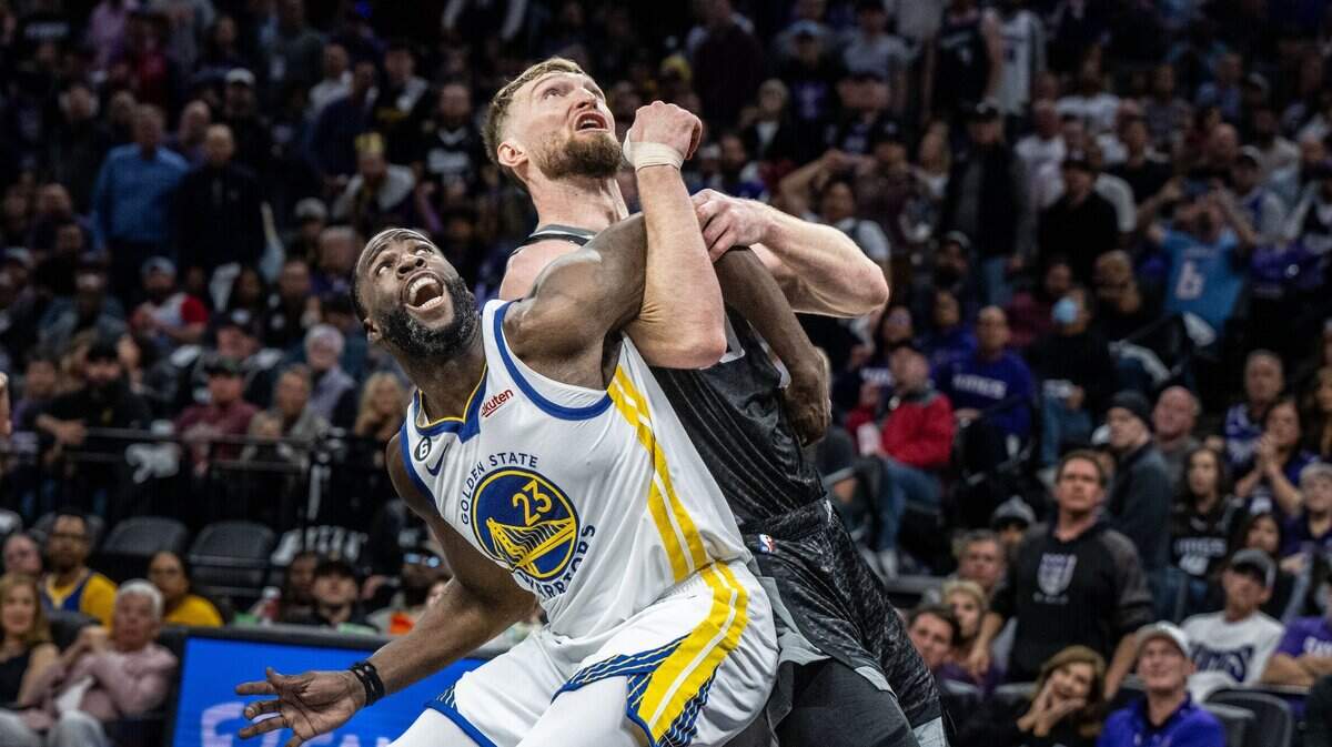 Golden State Warriors forward Draymond Green (23) and Sacramento Kings center Domantas Sabonis (10) get tangled up as they look for the ball during Game 2 of the first-round NBA playoff series at Golden 1 Center on Monday, April 17, 2023. Green was later suspended from game three after stepping on Sabonis’ chest who grabbed his leg while he was on the ground.